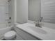 Modern bathroom featuring double sinks, quartz countertop, shower with glass door at 13562 Whitman Ln, Covington, GA 30014