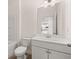 Bathroom featuring vanity with white cabinets, tile floor, and large mirror at 13562 Whitman Ln, Covington, GA 30014