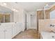 Modern bathroom with double vanity, tiled shower, and separate tub for a spa-like experience at 13562 Whitman Ln, Covington, GA 30014