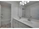 Bathroom with double sinks, large mirror, and modern lighting fixtures above at 13562 Whitman Ln, Covington, GA 30014