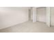 Bright bedroom with neutral carpet and an open closet featuring folding doors at 13562 Whitman Ln, Covington, GA 30014