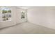 Bright bedroom featuring two windows offering pleasant views of the neighborhood at 13562 Whitman Ln, Covington, GA 30014