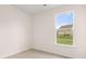 A bright bedroom features a large window overlooking the backyard at 13562 Whitman Ln, Covington, GA 30014