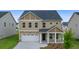 Charming two-story home with a welcoming front porch and a two-car garage at 13562 Whitman Ln, Covington, GA 30014