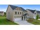 Well-maintained home featuring a two-car garage, a welcoming covered porch, and a neatly manicured lawn at 13562 Whitman Ln, Covington, GA 30014