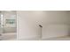 Hallway with light neutral walls and carpet, and views to the kitchen through a doorway at 13562 Whitman Ln, Covington, GA 30014