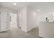 Upstairs hallway with neutral walls and carpet, with open rooms to let the sunshine in at 13562 Whitman Ln, Covington, GA 30014