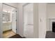 Hallway view featuring access to a bathroom and bedroom with fireplace at 13562 Whitman Ln, Covington, GA 30014