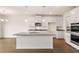 Spacious kitchen with a large island, stainless steel appliances, and dark hardwood floors at 13562 Whitman Ln, Covington, GA 30014