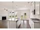 Open-concept kitchen with stainless steel appliances, island, and view into the living room at 13562 Whitman Ln, Covington, GA 30014