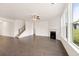 Bright living room with fireplace, hardwood floors, staircase, and large windows with natural light at 13562 Whitman Ln, Covington, GA 30014