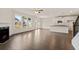 Spacious open-concept living room featuring a fireplace, hardwood floors, and an island with bar seating at 13562 Whitman Ln, Covington, GA 30014