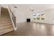 Spacious living room with staircase, fireplace, large windows, and hardwood floors at 13562 Whitman Ln, Covington, GA 30014