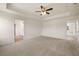 Large main bedroom boasts a tray ceiling and neutral color palette at 13562 Whitman Ln, Covington, GA 30014