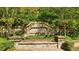 Stone community sign reading 'Wildwood', surrounded by lush landscaping at 13562 Whitman Ln, Covington, GA 30014