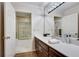 Bright bathroom with a marble tiled shower and a modern vanity with a white countertop at 24 Ball Creek Hl, Atlanta, GA 30350