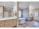 A luxurious bathroom with a soaking tub, double vanity, and marble accents exudes elegance at 24 Ball Creek Hl, Atlanta, GA 30350