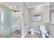 The luxurious bathroom includes a tiled shower and toilet with frosted glass for privacy and unique stone flooring at 24 Ball Creek Hl, Atlanta, GA 30350