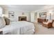 Bright bedroom with a fireplace, neutral carpet, and a doorway leading to an ensuite bathroom at 24 Ball Creek Hl, Atlanta, GA 30350