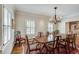 Bright dining room with shuttered windows and seating for eight around a wooden table at 24 Ball Creek Hl, Atlanta, GA 30350