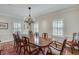 Elegant dining room with a classic chandelier and ample natural light from shuttered windows at 24 Ball Creek Hl, Atlanta, GA 30350