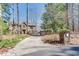 Long driveway leading to a traditional brick home and a two-car garage at 24 Ball Creek Hl, Atlanta, GA 30350