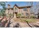 Traditional brick home with attached garage with mature trees and landscaped front yard at 24 Ball Creek Hl, Atlanta, GA 30350
