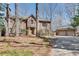 Traditional brick home with attached two-car garage and professionally landscaped front yard and mature trees at 24 Ball Creek Hl, Atlanta, GA 30350