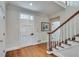 Hardwood foyer with adjacent carpeted stairs and white door with ornate trim at 24 Ball Creek Hl, Atlanta, GA 30350