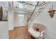 Hardwood foyer with a white door with glass and a view of the stairs and bench at 24 Ball Creek Hl, Atlanta, GA 30350