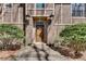 Close up of a front door framed by lamps and shrubbery leading to a brick path at 24 Ball Creek Hl, Atlanta, GA 30350