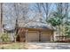 A detached two-car garage with a brick exterior and neutral-colored doors and roof at 24 Ball Creek Hl, Atlanta, GA 30350