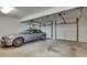 A two-car garage interior featuring a silver sedan parked inside and white doors at 24 Ball Creek Hl, Atlanta, GA 30350
