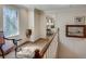 Bright hallway with hardwood floors, elegant chair and table, and stained glass window at 24 Ball Creek Hl, Atlanta, GA 30350
