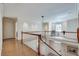 Open hallway and staircase with hardwood floors, white railings, and natural light at 24 Ball Creek Hl, Atlanta, GA 30350