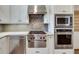 Gourmet kitchen with stainless steel KitchenAid appliances and white cabinetry at 24 Ball Creek Hl, Atlanta, GA 30350