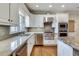 Corner kitchen featuring granite countertops, stainless appliances and a view from the window at 24 Ball Creek Hl, Atlanta, GA 30350