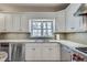 Modern kitchen boasts stainless steel appliances and an abundance of crisp white cabinets at 24 Ball Creek Hl, Atlanta, GA 30350