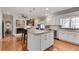 Open kitchen featuring white cabinets, granite countertops, stainless appliances and large island at 24 Ball Creek Hl, Atlanta, GA 30350