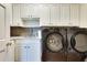 Convenient laundry room featuring modern washer and dryer, sink, and cabinets at 24 Ball Creek Hl, Atlanta, GA 30350