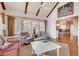 Cozy living room with exposed beams, fireplace, lots of windows, and an open floorplan at 24 Ball Creek Hl, Atlanta, GA 30350