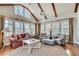 Comfortable living room with vaulted ceilings, wood beams, and a wall of windows at 24 Ball Creek Hl, Atlanta, GA 30350