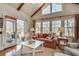 Bright living room with vaulted ceilings, exposed beams, and door to exterior deck at 24 Ball Creek Hl, Atlanta, GA 30350