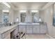 Bright main bathroom with double sinks, marble countertops, vanity space and neutral tiling at 24 Ball Creek Hl, Atlanta, GA 30350