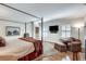 Bright main bedroom has hardwood floors, a sitting area, and a large bed with natural light at 24 Ball Creek Hl, Atlanta, GA 30350