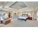 Spacious main bedroom features tray ceilings, neutral carpeting, an attached sitting room, and double doors to the ensuite bathroom at 24 Ball Creek Hl, Atlanta, GA 30350