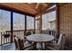 Charming screened porch with wood ceiling and stone flooring, perfect for outdoor dining at 24 Ball Creek Hl, Atlanta, GA 30350