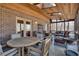 Spacious screened porch with brick detail, wood ceiling, skylights, and multiple seating areas, perfect for relaxing at 24 Ball Creek Hl, Atlanta, GA 30350
