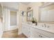 Lovely primary bath features double sinks, decorative mirror, and shower-tub combination at 276 Atlanta Se Ave, Atlanta, GA 30315