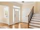 Welcoming foyer with hardwood floors, a front door with sidelights, and an elegant staircase at 276 Atlanta Se Ave, Atlanta, GA 30315